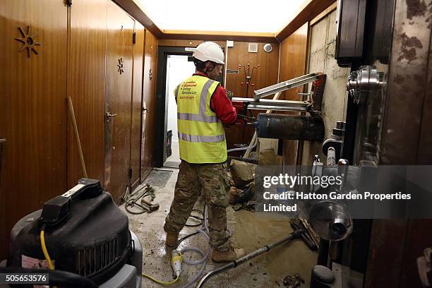 Diamond driller Sunny Kirby drills a hole in the wall used by burglars to access the underground vault of the Hatton Garden Safe Deposit Company...