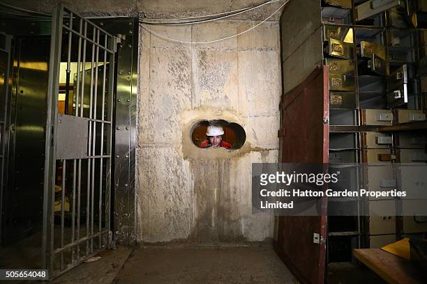 Diamond driller Sunny Kirby looks through the hole used by burglars to access the underground vault of the Hatton Garden Safe Deposit Company which...