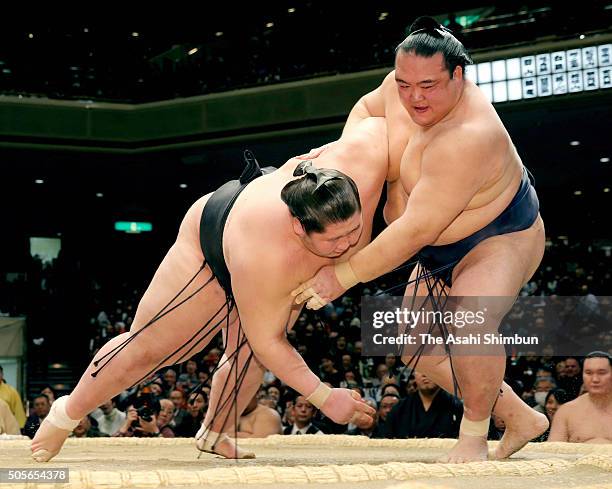 Ozeki Kisenosato throws Mongolian wrestler Ichinojo to win during day six of the Grand Sumo New Year Tournament at Ryogoku Kokugikan on January 15,...