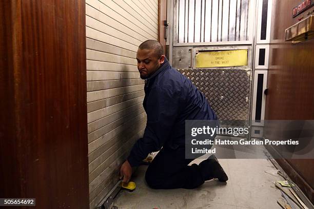 Caretaker opens the shutter to the lift shaft used to access the underground vault of the Hatton Garden Safe Deposit Company which was raided in what...