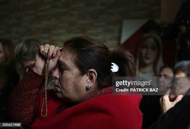 Lebanese Christian women hold hands during a mystical quasi-religious service in an appartment in a popular neighborhood of Beirut on January 19,...