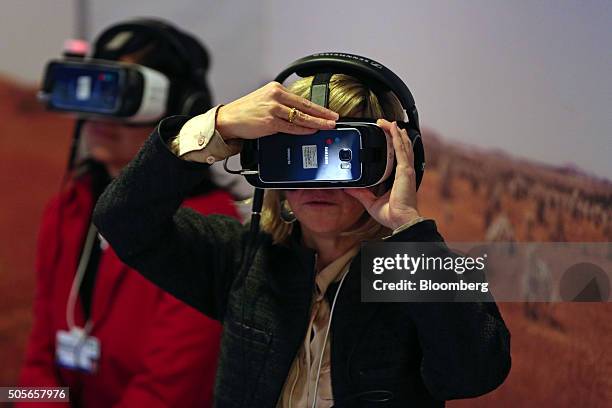 An attendee watches 'Collisions', a 15 minute film by artist Lynette Wallworth, on a Samsung Gear VR virtual reality headset, developed jointly by...