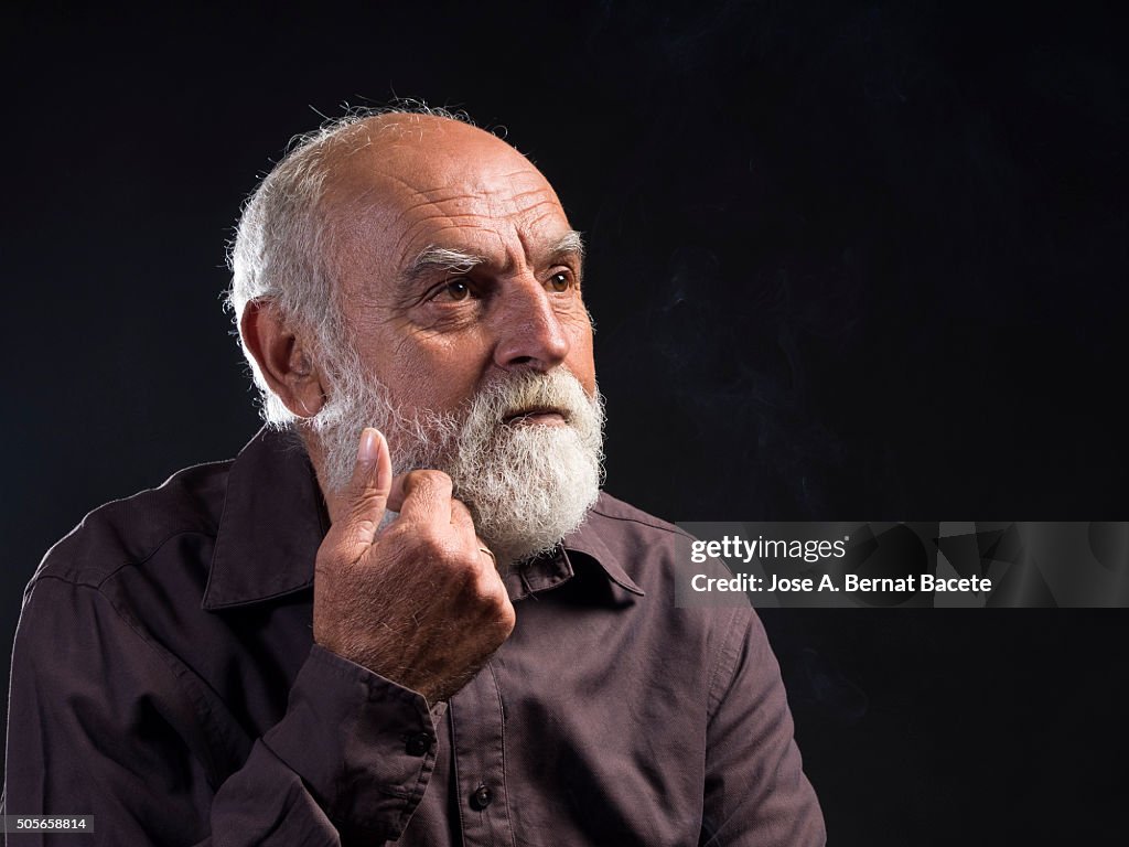 Adult hair and white beard thoughtfully and concern man.