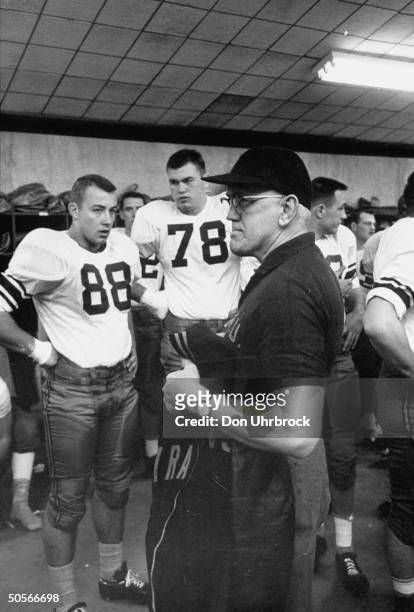 Syracuse Univ. Coach Floyd B. Schwartzwalder in locker room talking to players during Cotton Bowl game.