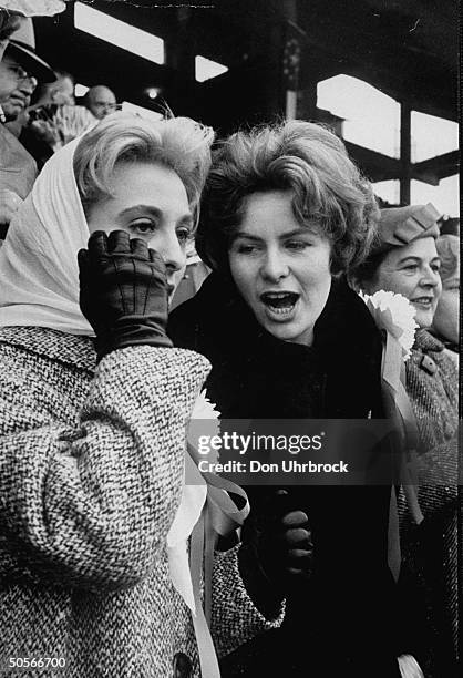 Syracuse Univ. Football players wives Mrs. Ger Schwedes and Mrs. Bob Yates watching their husbands during the Cotton Bowl game.