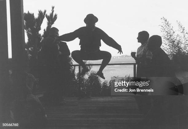 Silhouette of partygoer engaging in jumping fad.