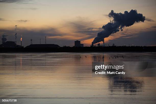 The sun rises behind the Tata steelworks on January 19, 2016 in Port Talbot, Wales. Tata Steel announced yesterday that it plans to cut 1,050 jobs in...