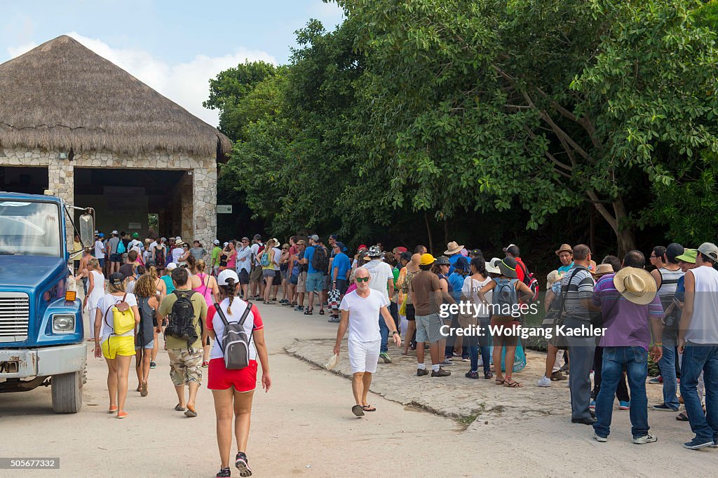 A long line of tourists at the ticket counter at Tulum,...