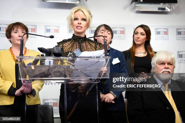 Actress Pamela Anderson gives a press conference next to environmental activist Paul Watson after attending a session of questions to the Government...