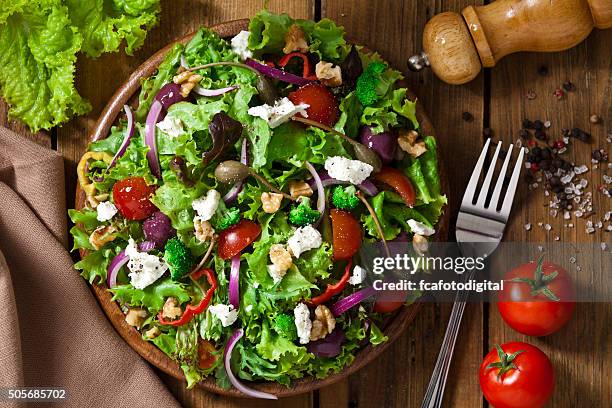spring salad shot from above on rustic wood table - salades stock pictures, royalty-free photos & images