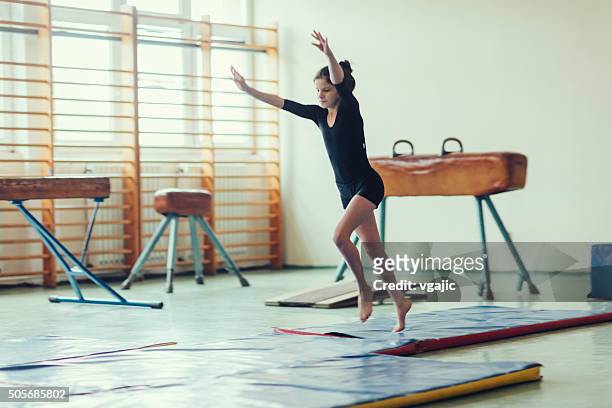girl practicing gymnastics. - school gymnastics stock pictures, royalty-free photos & images