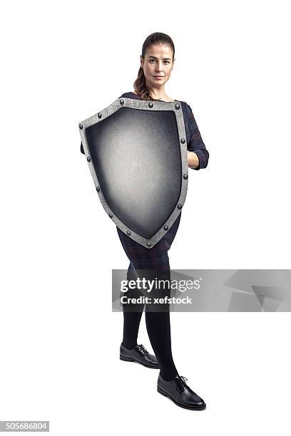 woman protecting herself with a shield - business woman schild stockfoto's en -beelden