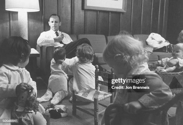 Father of family watching his own and neighbors kids, in baby-sitting co-op.