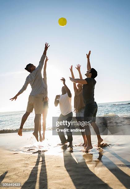people playing volleyball at the beach - beach volleyball friends stock pictures, royalty-free photos & images