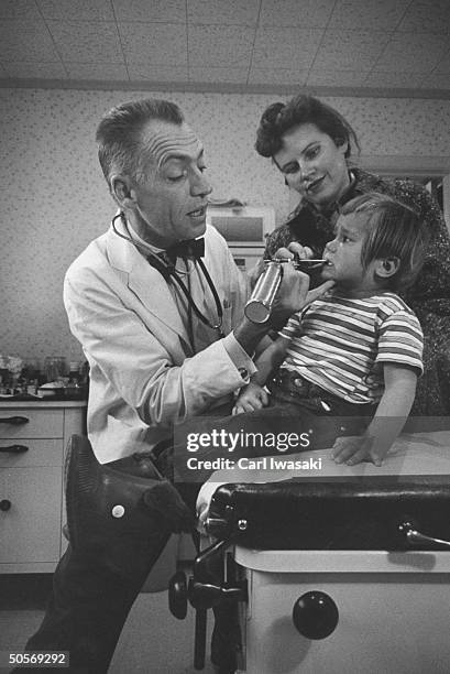 Dr. Ernest Ceriani examining a child with an infected ear.