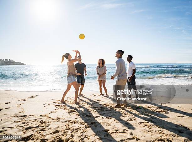 gruppe von menschen spielen sie beach-volleyball - womens beach volleyball stock-fotos und bilder