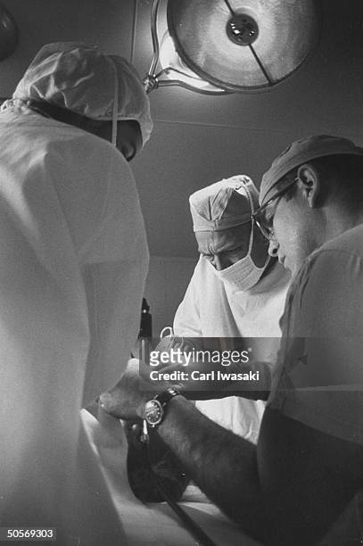 Dr. Ernest Ceriani performing an operation on Crystal Parie.