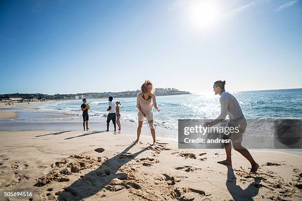couple playing badminton at the beach - sydney beach stock pictures, royalty-free photos & images