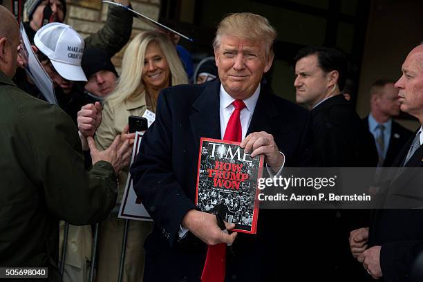 Republican presidential candidate Donald Trump holds a copy of Time Magazine outside the John Wayne Birthplace Museum on January 19, 2016 in...