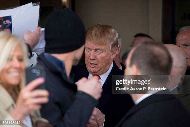 Republican presidential candidate Donald Trump signs autographs outside the John Wayne Birthplace Museum on January 19, 2016 in Winterset, Iowa....