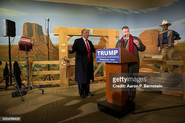 Republican presidential candidate Donald Trump looks on as Trump state director Chuck Laudner speaks at the John Wayne Birthplace Museum on January...