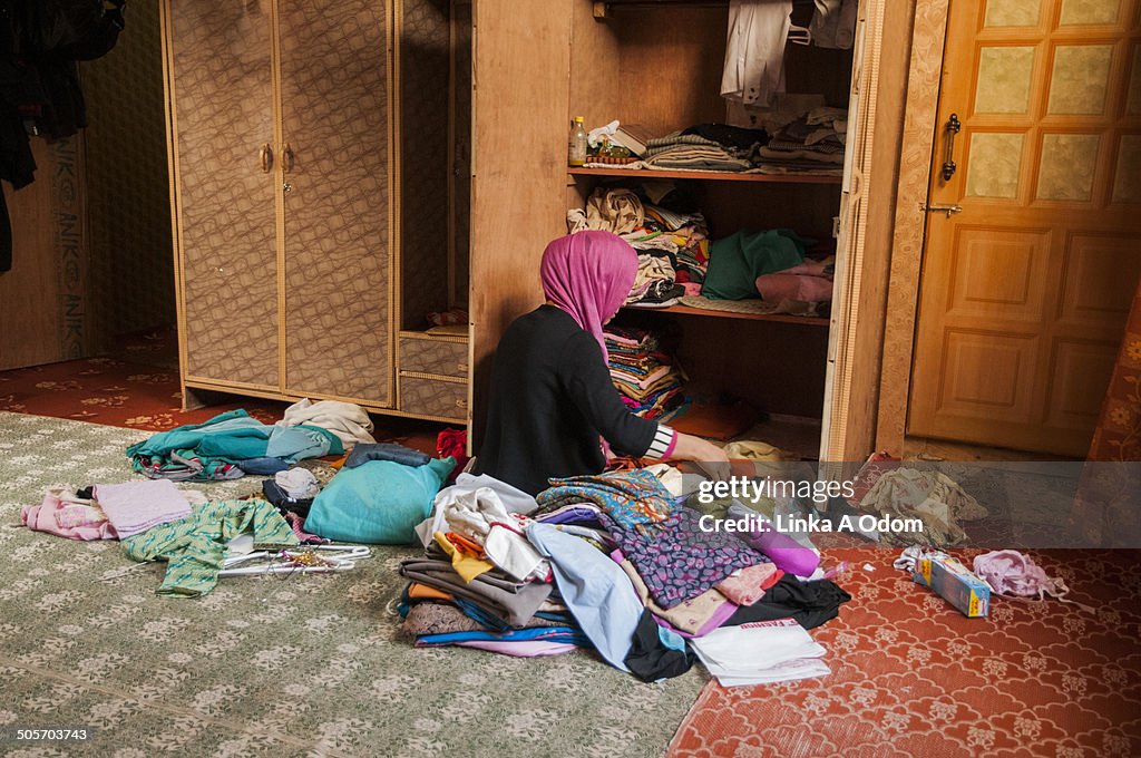 A Muslim Girl Organizing Clean Laundry