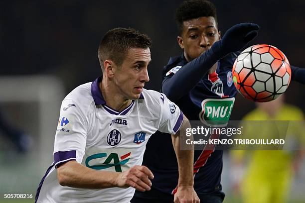 Paris Saint-Germain's French defender Presnel Kimpembe vies with Toulouse's Serbian forward Aleksandar Pesic during the French Cup football match...