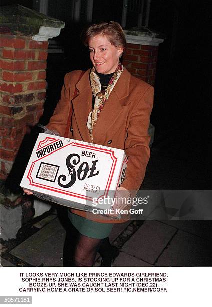 Sophie Rhys-Jones, friend of Britain's Prince Edward, carrying what appears to be a case of Sol beer.