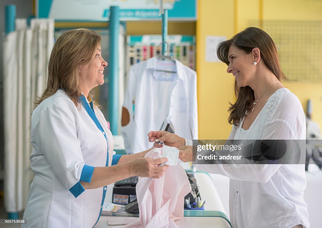 Woman taking clothes to the laundry shop