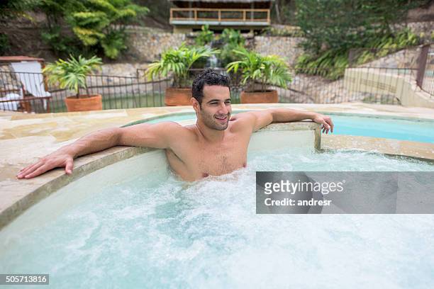 man relaxing in the hot tub - hot tub stock pictures, royalty-free photos & images