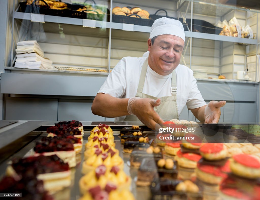 Happy man baking sweet treats