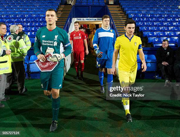 Ryan Fulton of Liverpool and Lewie Coyle of Leeds United lead their teams out for the Liverpool v Leeds United U21 Premier League Cup game at Prenton...