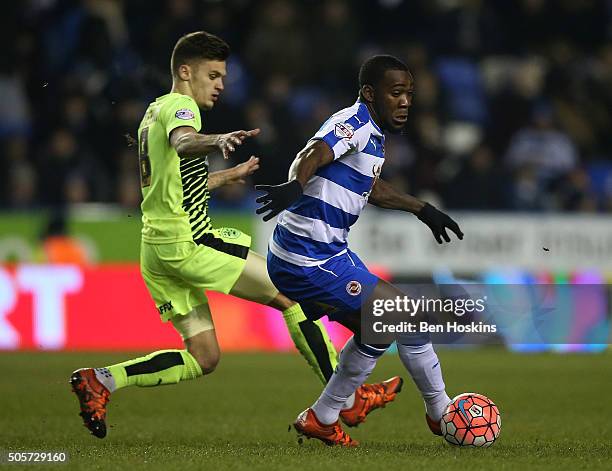 Ola John of Reading holds off pressure from Jamie Paterson of Huddersfield during The Emirates FA Cup Second Round match between Reading and...