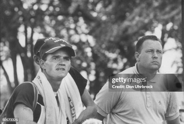 Open golf champ Billy Casper and his caddy watch path of ball during US open tournament.
