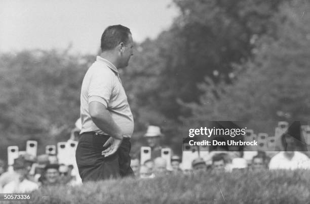 Billy Casper during the US open golf championship as fans in background look on.