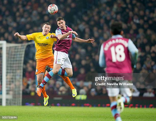 Ciaran Clark of Aston Villa is challenged by Gary Thompson of Wycombe Wanderers during the FA Cup Third Round Relay match between Aston Villa and...