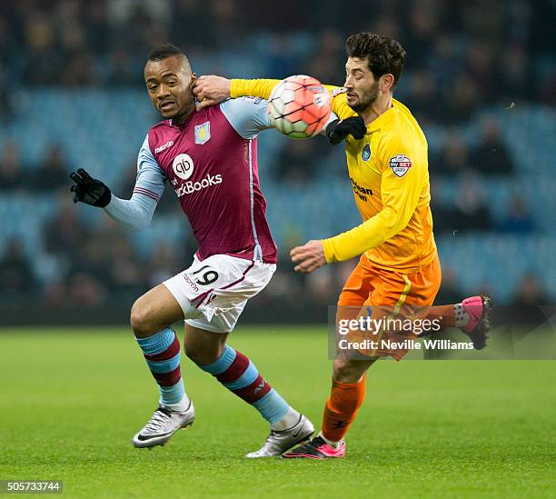 Jordan Ayew of Aston Villa is challenged by Joe Jacobson of Wycombe Wanderers during the FA Cup Third Round Relay match between Aston Villa and...