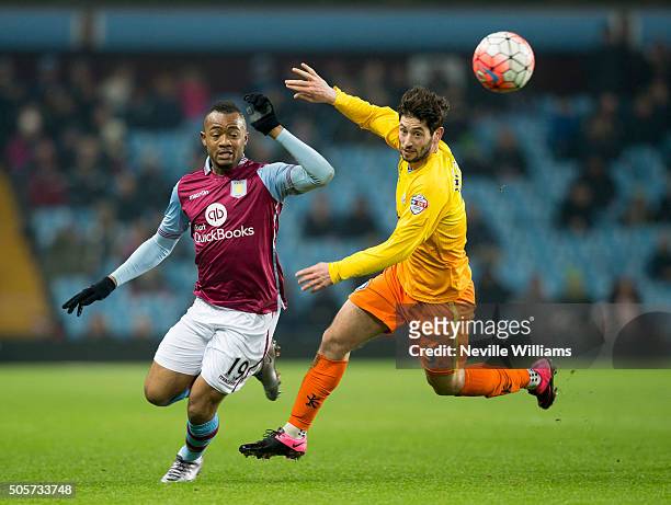 Jordan Ayew of Aston Villa is challenged by Joe Jacobson of Wycombe Wanderers during the FA Cup Third Round Relay match between Aston Villa and...
