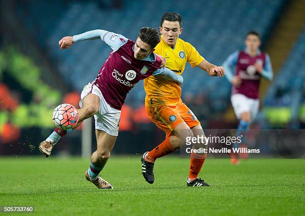 Jack Grealish of Aston Villa is challenged by Luke O'Nien of Wycombe Wanderers during the FA Cup Third Round Relay match between Aston Villa and...
