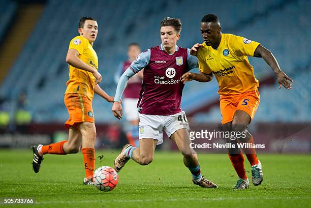 Jack Grealish of Aston Villa is challenged by Anthony Stewart of Wycombe Wanderers during the FA Cup Third Round Relay match between Aston Villa and...