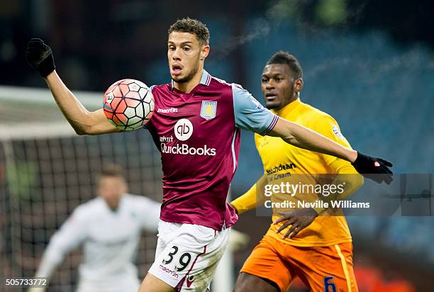 Rudy Gestede of Aston Villa is challenged by Aaron Pierre of Wycombe Wanderers during the FA Cup Third Round Relay match between Aston Villa and...