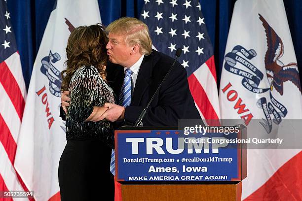 Republican presidential candidate Donald Trump kisses former Alaska Gov. Sarah Palin speaks as she endorses him at a campaign stop, Tuesday, Jan. 19...