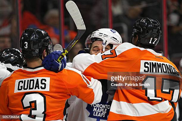 Parenteau of the Toronto Maple Leafs is pushes around by Wayne Simmonds and Radko Gudas of the Philadelphia Flyers during the first period at Wells...