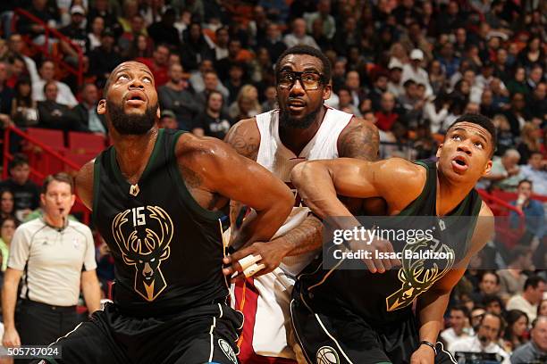 Greg Monroe of the Milwaukee Bucks and Giannis Antetokounmpo of the Milwaukee Bucks fights for position against Amar'e Stoudemire of the Miami Heat...