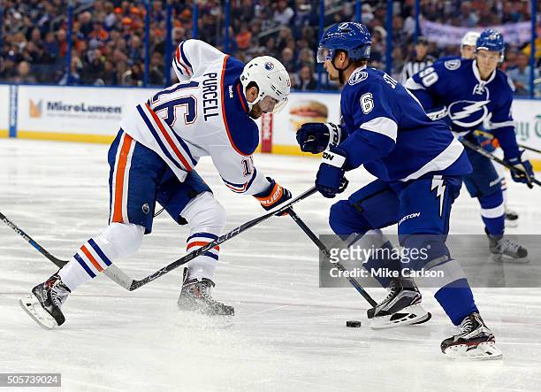 Teddy Purcell of the Edmonton Oilers tries to avoid the check from Anton Stralman of the Tampa Bay Lightning at the Amalie Arena on January 19, 2016...