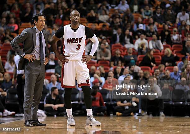 Head coach Erik Spoelstra of the Miami Heat and Dwyane Wade talk during a game against the Milwaukee Bucks at American Airlines Arena on January 19,...