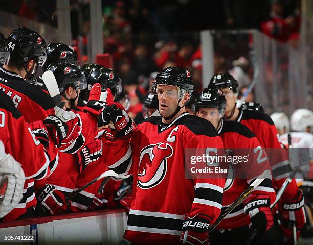 Andy Greene of the New Jersey Devils celebrates his empty net goal with teammates on the bench in the third period against the Calgary Flames on...