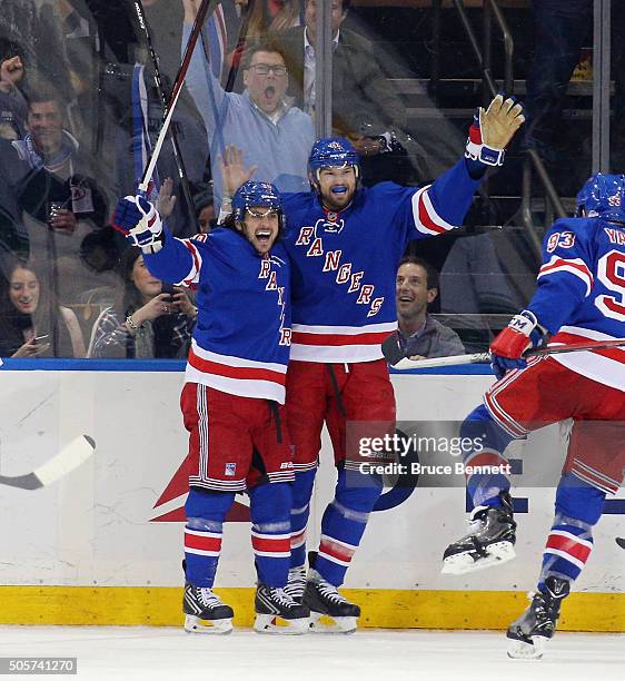 Mats Zuccarello of the New York Rangers celebrates his goal at 11:46 of the third period against the Vancouver Canucks and is joined by Rick Nash at...