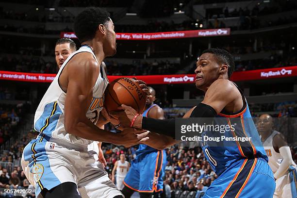 Russell Westbrook of the Oklahoma City Thunder is called for a foul as he battles Gary Harris of the Denver Nuggets for the ball at Pepsi Center on...