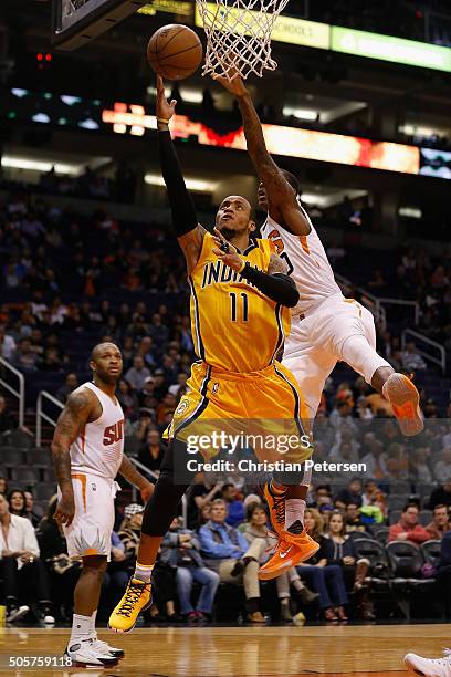 Monta Ellis of the Indiana Pacers lays up a shot past Archie Goodwin of the Phoenix Suns during the second half of the NBA game at Talking Stick...